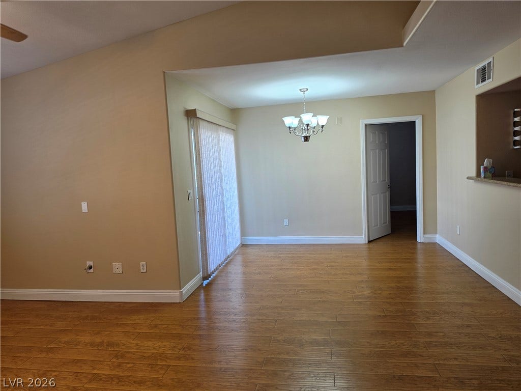 8000 W Badura Avenue, #2111, Las Vegas, NV 89113 Warm wood flooring and an open layout create an inviting dining area.