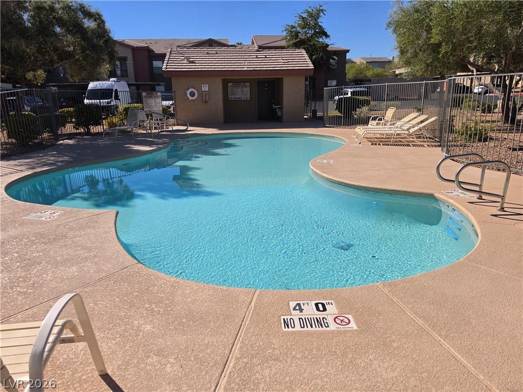 8000 W Badura Avenue, #2111, Las Vegas, NV 89113 A sparkling community pool sits surrounded by a spacious concrete deck and secure fencing.