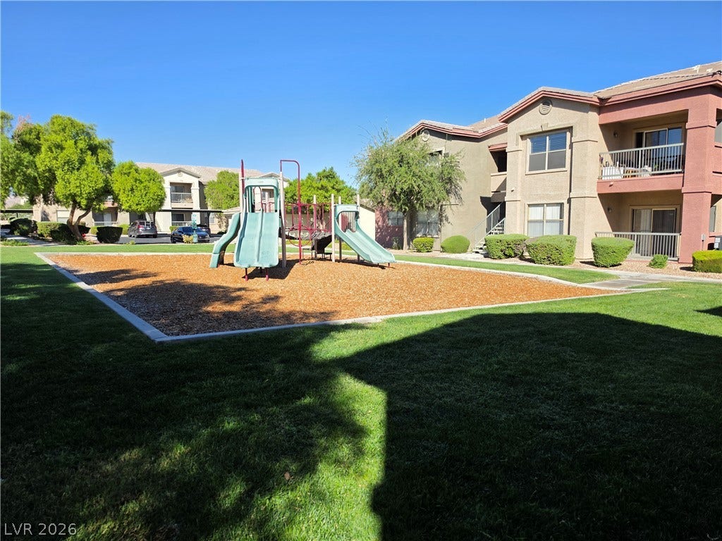 8000 W Badura Avenue, #2111, Las Vegas, NV 89113 An on-site playground sits surrounded by manicured lawns next to residential buildings.