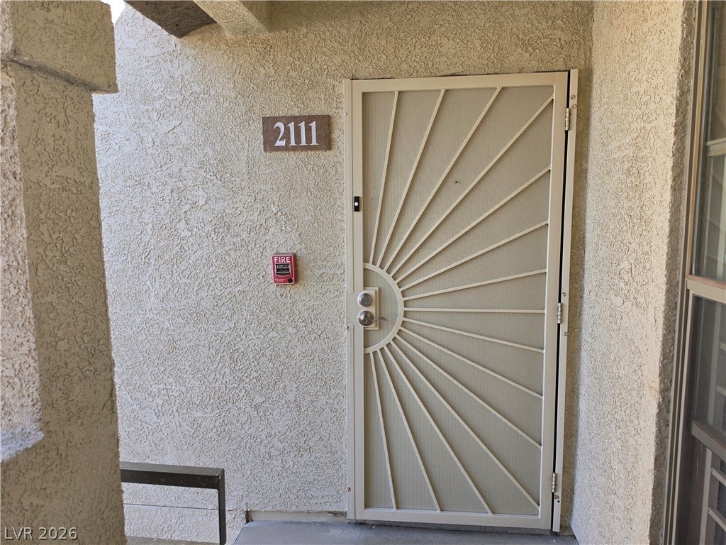8000 W Badura Avenue, #2111, Las Vegas, NV 89113 A secure entry door set against textured stucco walls provides a private welcome.