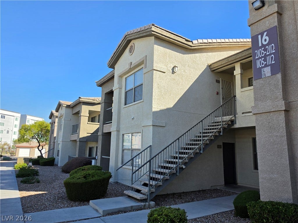 8000 W Badura Avenue, #2111, Las Vegas, NV 89113 Stucco exterior walls and concrete stairs define this multi-family residential building.