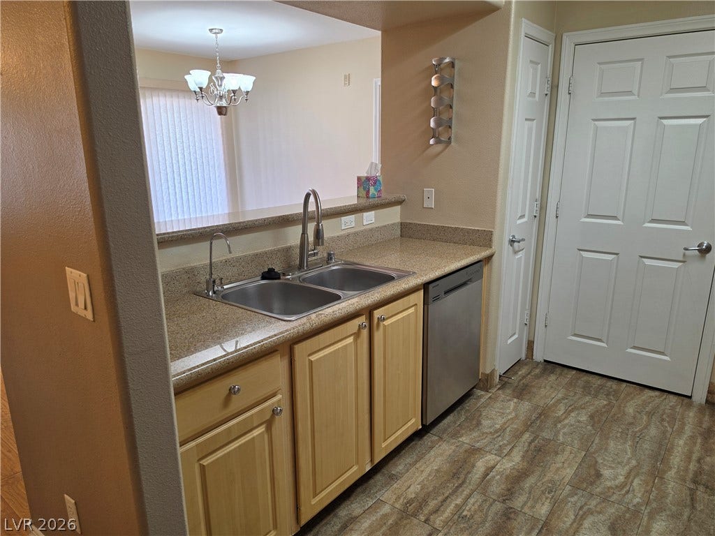 8000 W Badura Avenue, #2111, Las Vegas, NV 89113 Granite counters and solid cabinetry highlight this functional kitchen area opening to the dining room.
