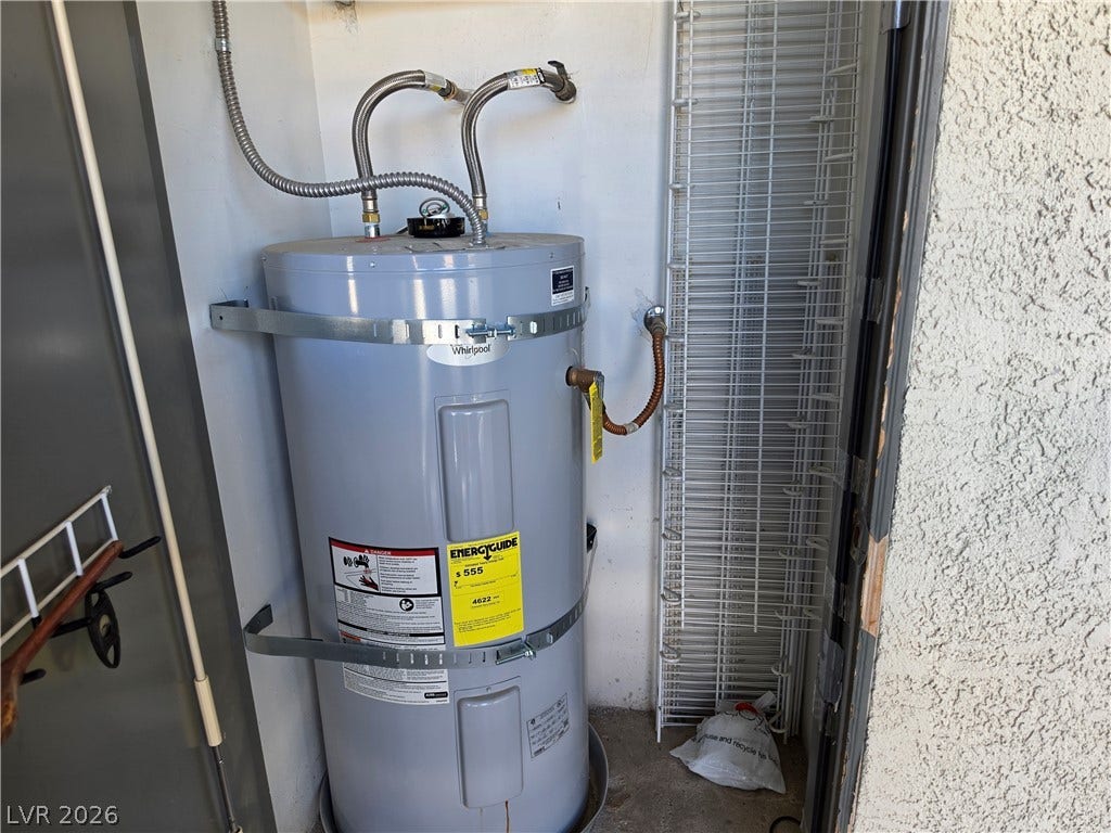 8000 W Badura Avenue, #2111, Las Vegas, NV 89113 An organized utility space houses a dedicated water heater alongside integrated wire shelving.