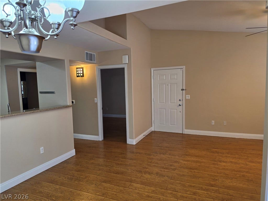 8000 W Badura Avenue, #2111, Las Vegas, NV 89113 Rich wood flooring anchors the entry space, which flows directly into the kitchen area.