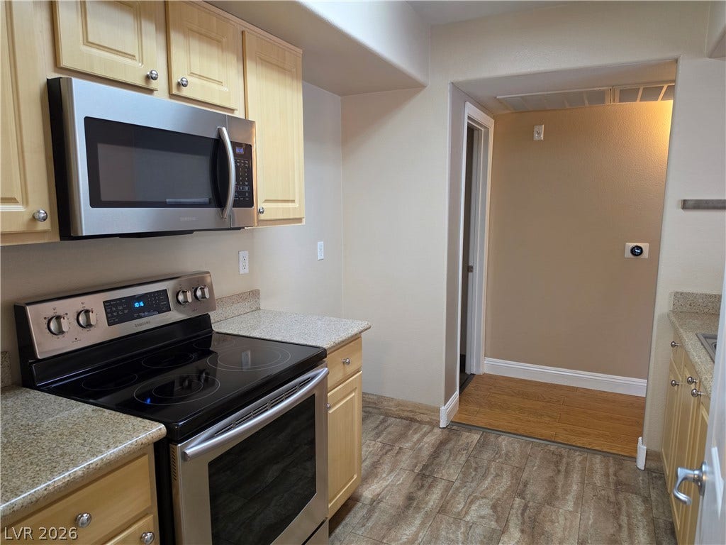 8000 W Badura Avenue, #2111, Las Vegas, NV 89113 Granite counters and stainless steel appliances anchor this functional kitchen layout.