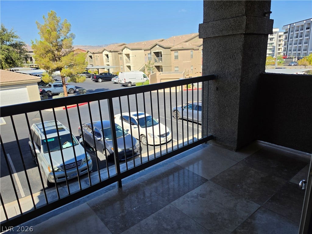 8000 W Badura Avenue, #2111, Las Vegas, NV 89113 A private covered balcony features durable tile flooring and overlooks the surrounding neighborhood.