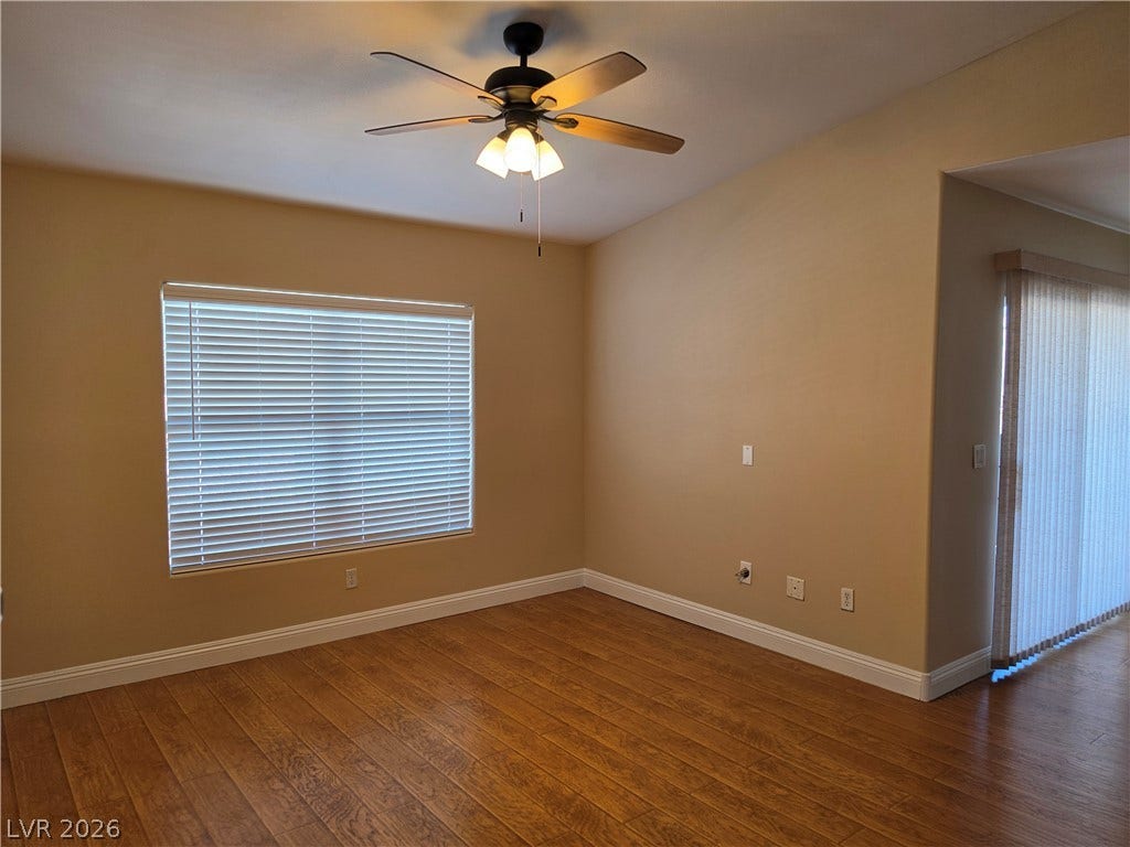 8000 W Badura Avenue, #2111, Las Vegas, NV 89113 Rich wood-plank flooring pairs with vaulted ceilings and wide windows in this inviting interior.