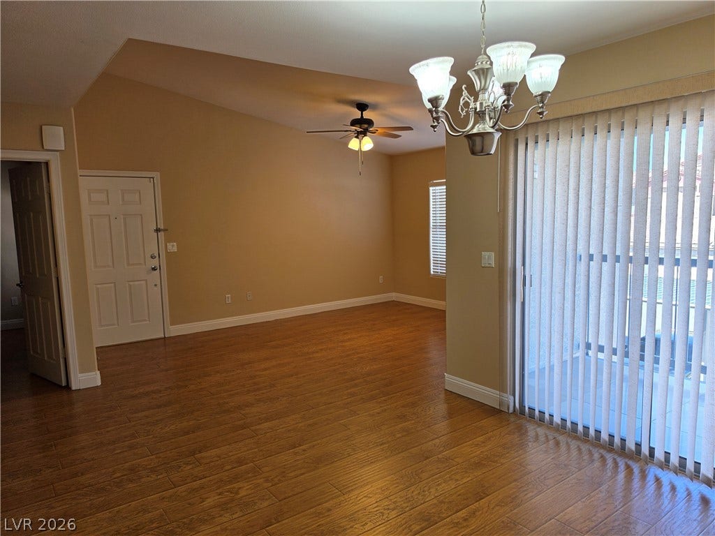 8000 W Badura Avenue, #2111, Las Vegas, NV 89113 Gleaming wood-look floors complement the vaulted ceiling and sliding glass doors in this airy space.