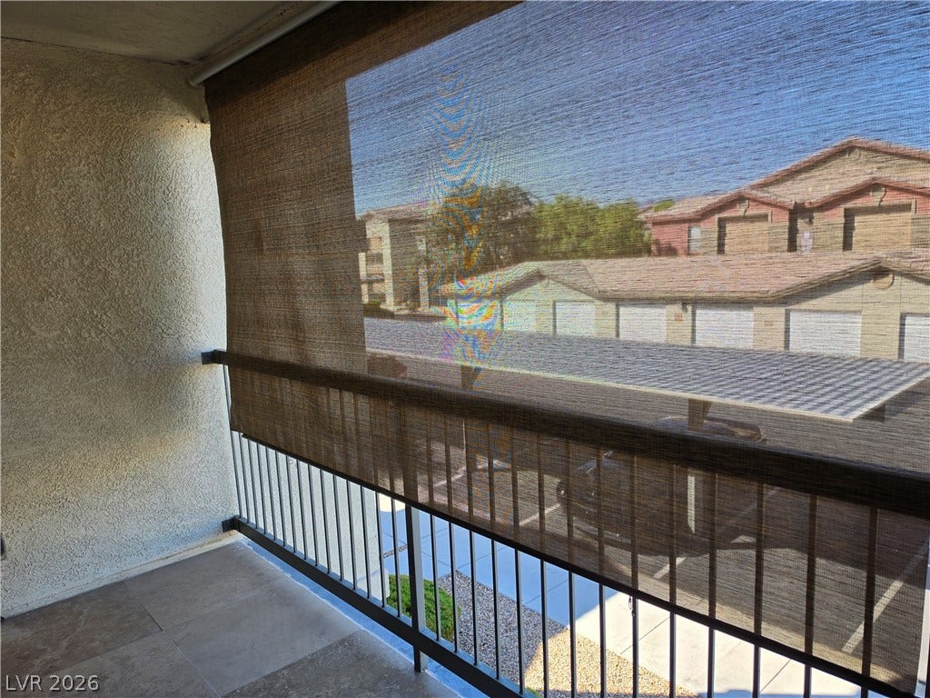 8000 W Badura Avenue, #2111, Las Vegas, NV 89113 Tiled flooring and sturdy railings define this covered balcony overlooking the surrounding neighborhood.
