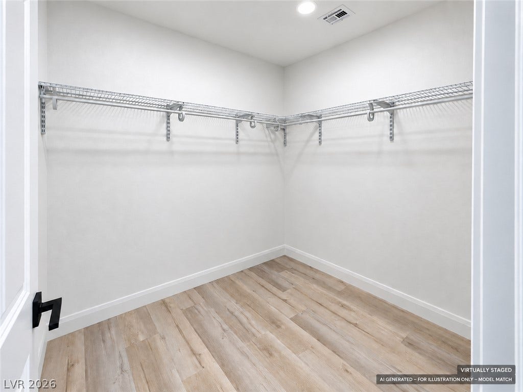 Virtually staged. Ample wire shelving lines this functional closet space featuring modern wood-look flooring.
