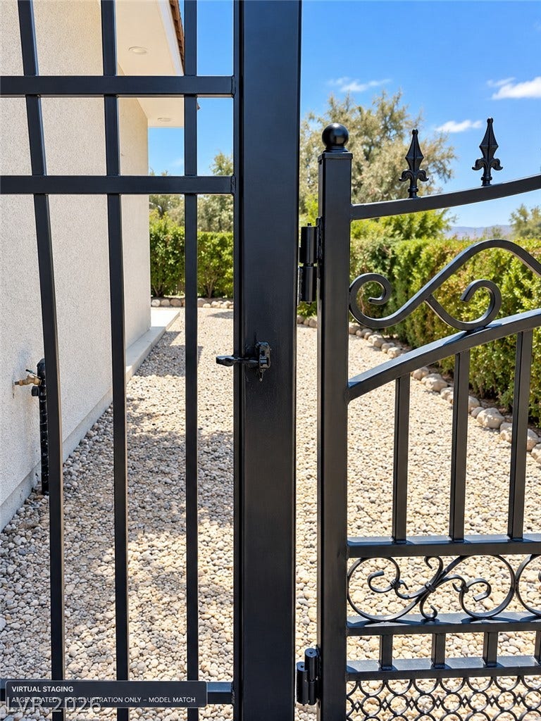 Virtually staged. 
An elegant wrought iron gate secures the landscaped gravel pathway beside the home.