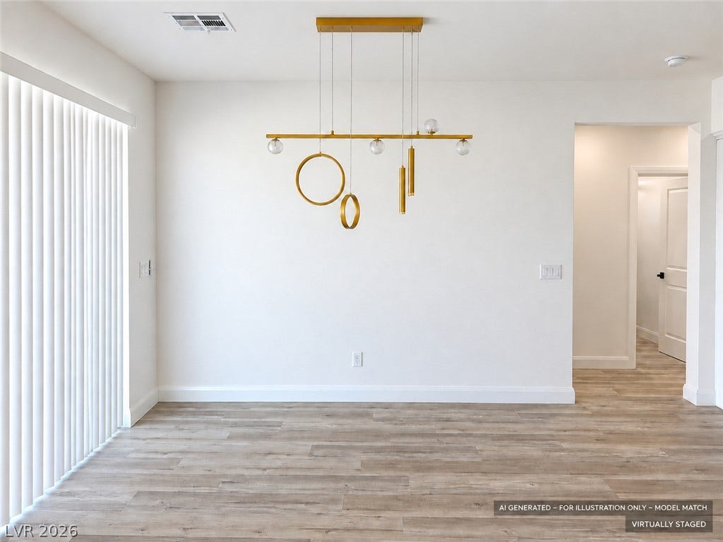 Virtually staged. Sliding doors invite natural light across the durable wood-look flooring of this versatile dining space.