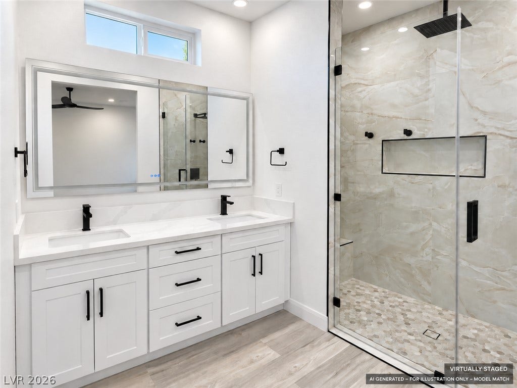 Virtually staged. A spacious double vanity pairs perfectly with a modern, glass-enclosed walk-in shower.