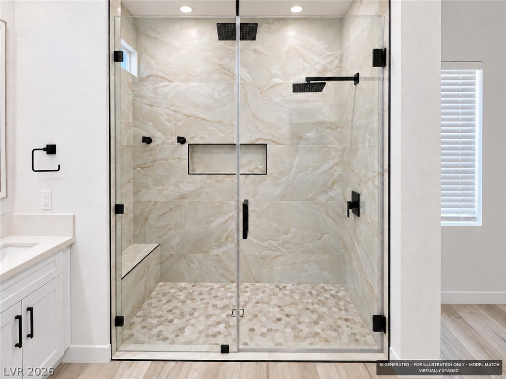 Virtually staged. Floor-to-ceiling tile surrounds a spacious walk-in shower with dual showerheads and matte black hardware.