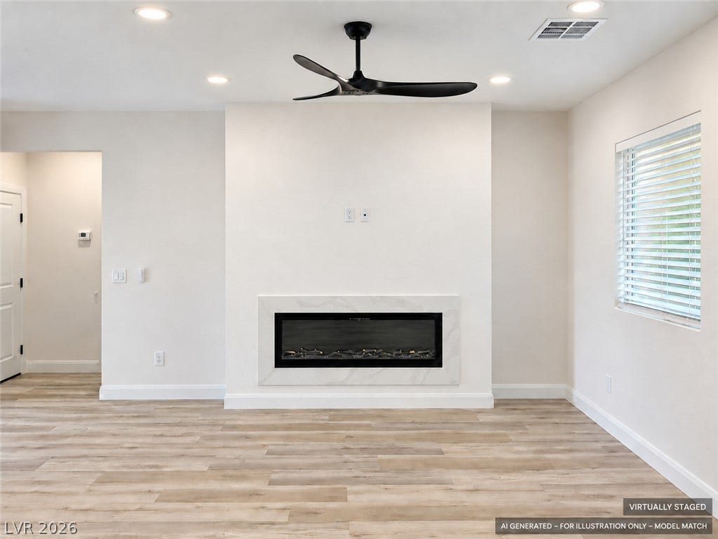 Virtually staged.  A modern fireplace highlights the clean architectural lines of this light-filled room with wood-style flooring.