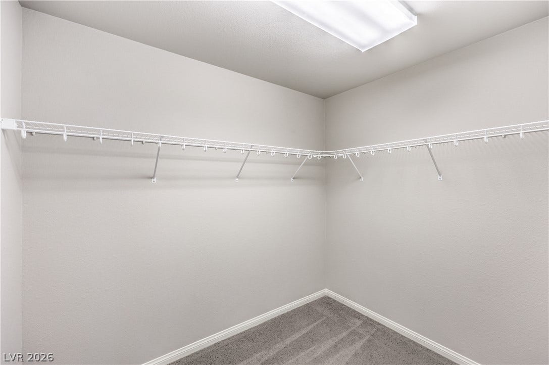 9267 Galen Glen Court, Las Vegas, NV 89139 A spacious walk-in closet includes wall-to-wall carpeting and built-in wire shelving.
