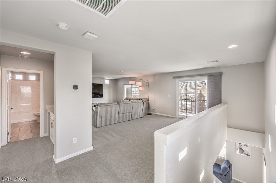 9267 Galen Glen Court, Las Vegas, NV 89139 An open upstairs loft features plush carpeting, recessed lighting, and a private balcony access.