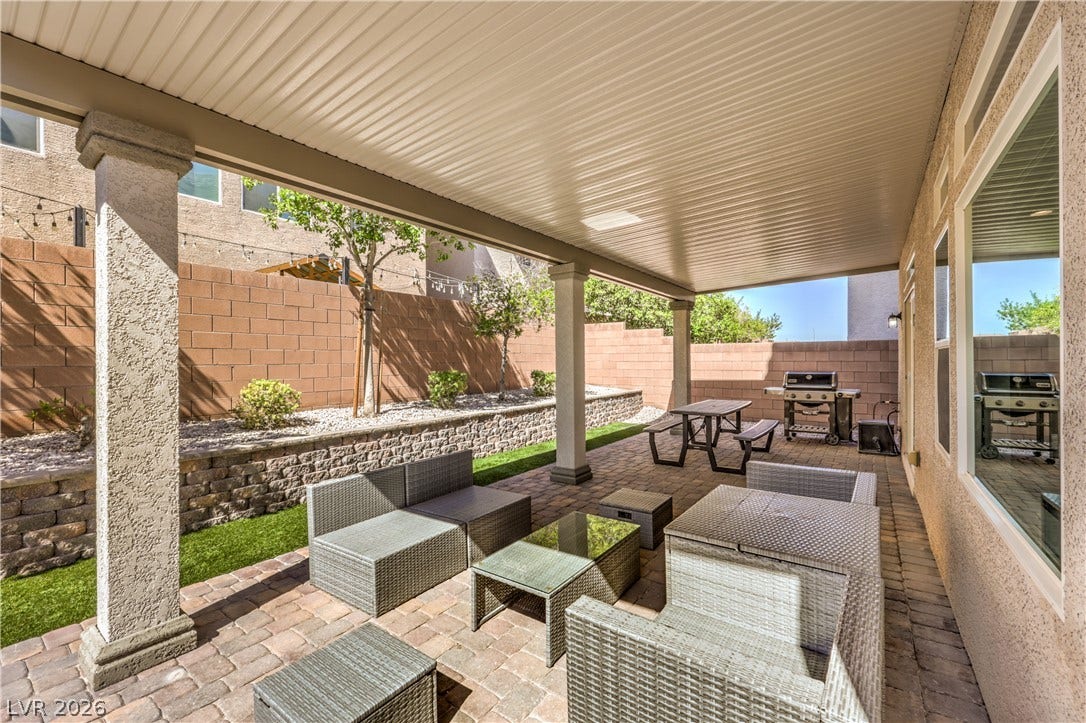 9267 Galen Glen Court, Las Vegas, NV 89139 A spacious covered patio features paver flooring alongside a walled backyard with low-maintenance landscaping.