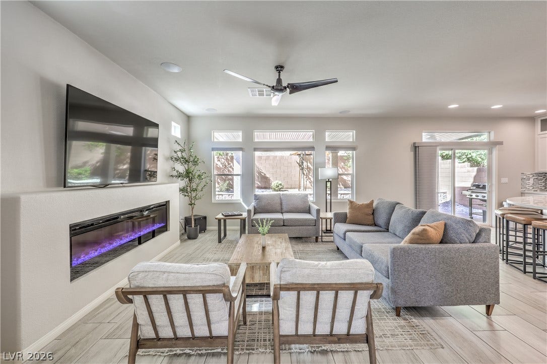 9267 Galen Glen Court, Las Vegas, NV 89139 An integrated electric fireplace anchors this airy living space illuminated by recessed lights.