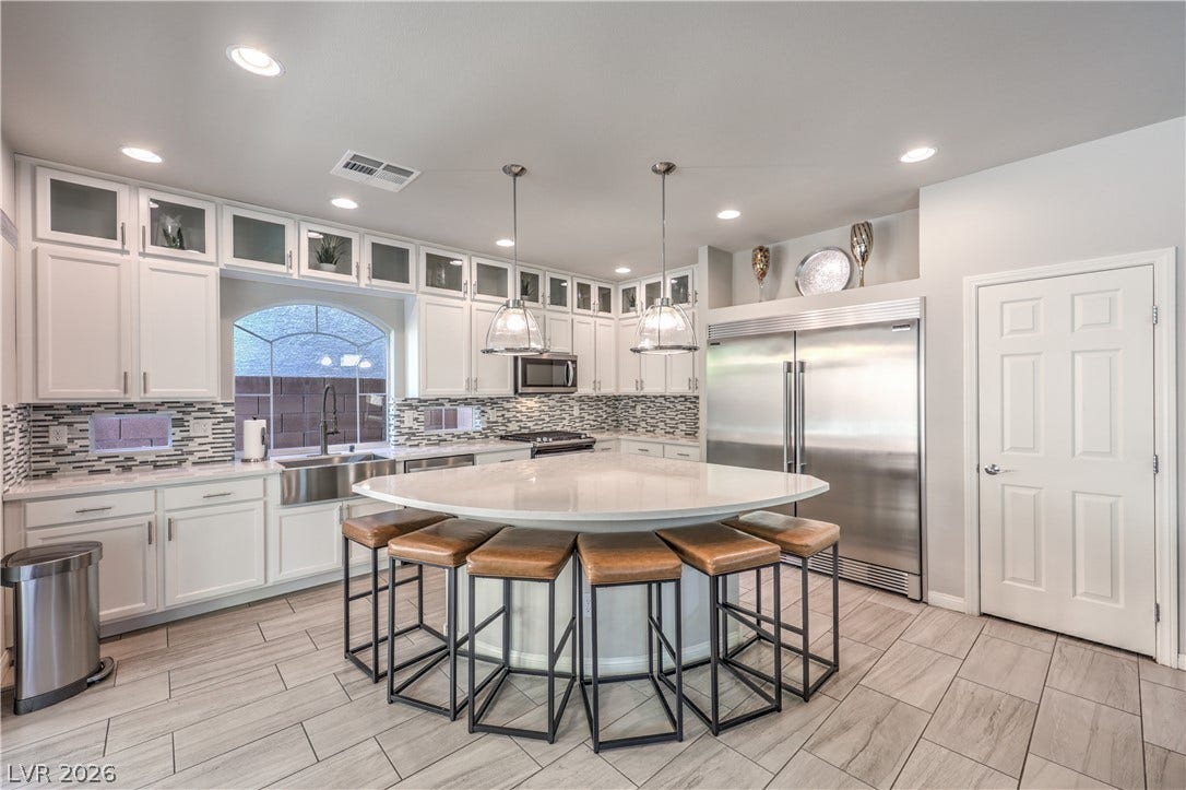 9267 Galen Glen Court, Las Vegas, NV 89139 Gleaming stone countertops and modern cabinetry elevate this open culinary space.