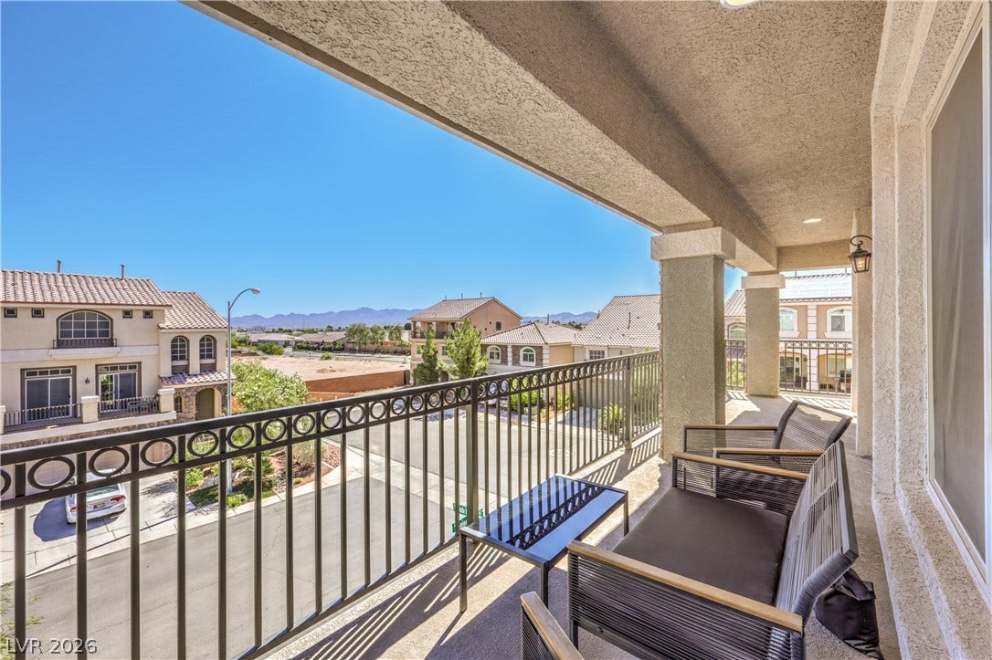 9267 Galen Glen Court, Las Vegas, NV 89139 An elevated covered balcony overlooks the surrounding neighborhood and distant mountain ridges.