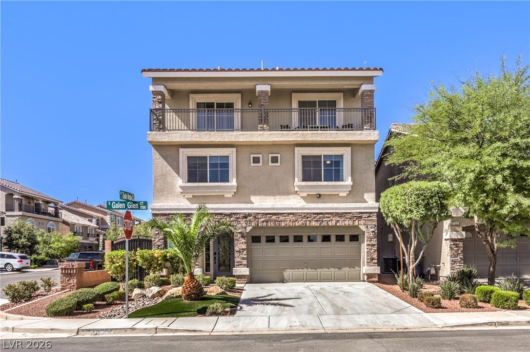 9267 Galen Glen Court, Las Vegas, NV 89139 A stone-accented facade and multi-level design create striking curb appeal under a clear sky.