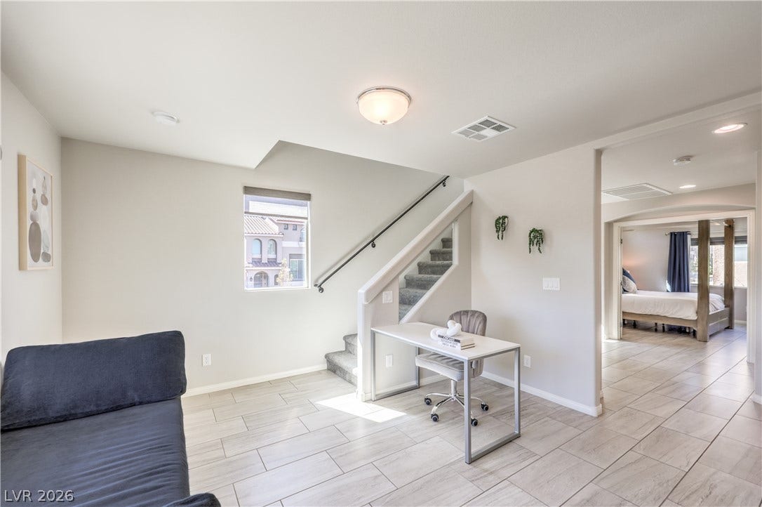 9267 Galen Glen Court, Las Vegas, NV 89139 Tiled flooring and a modern staircase to the third level define this versatile open interior space.