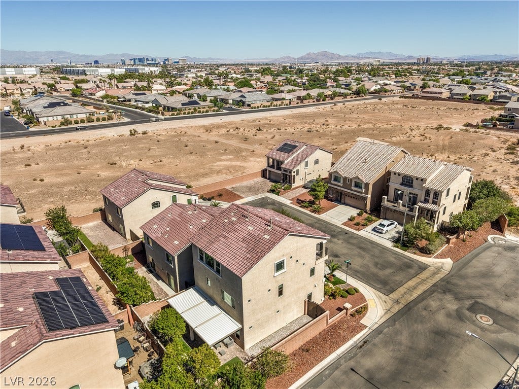 9267 Galen Glen Court, Las Vegas, NV 89139 Aerial view showcases the Las Vegas Strip, desert surroundings and distant mountain ranges framing this residential community.