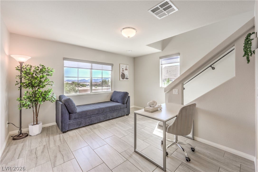 9267 Galen Glen Court, Las Vegas, NV 89139 Gleaming tile floors and natural light from large windows define this versatile study space.