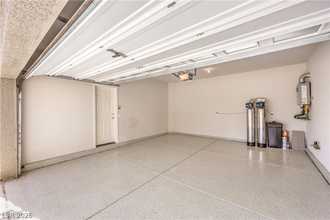 9267 Galen Glen Court, Las Vegas, NV 89139 Clean epoxy flooring and integrated utility systems elevate this functional garage space.