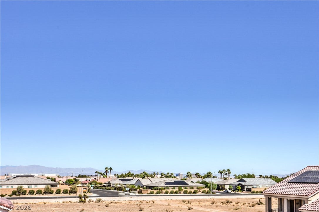 9267 Galen Glen Court, Las Vegas, NV 89139 Distant mountains frame a wide desert neighborhood view under clear blue skies.