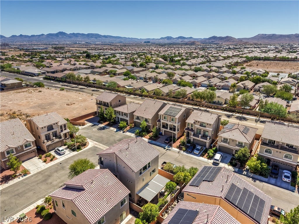 9267 Galen Glen Court, Las Vegas, NV 89139 An aerial perspective showcases a neat residential neighborhood framed by majestic distant mountains.