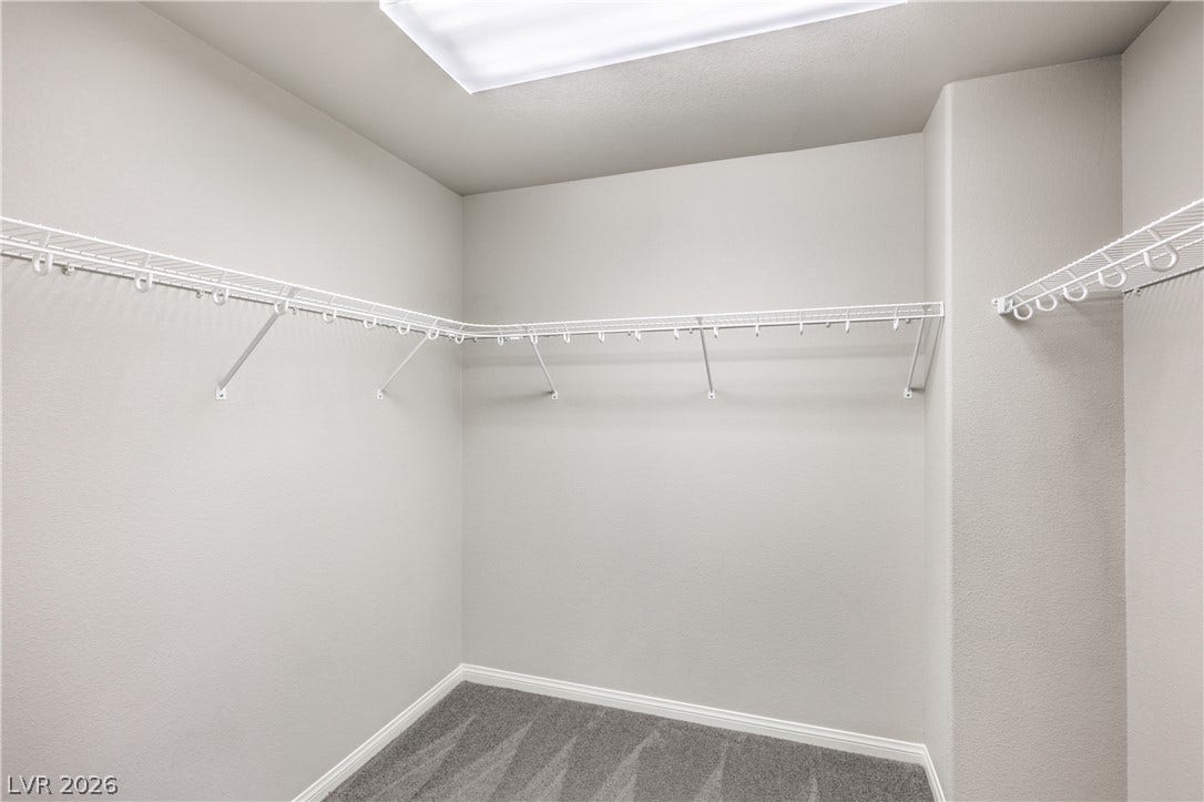 9267 Galen Glen Court, Las Vegas, NV 89139 Ample wire shelving and soft carpeting define this functional walk-in closet space.