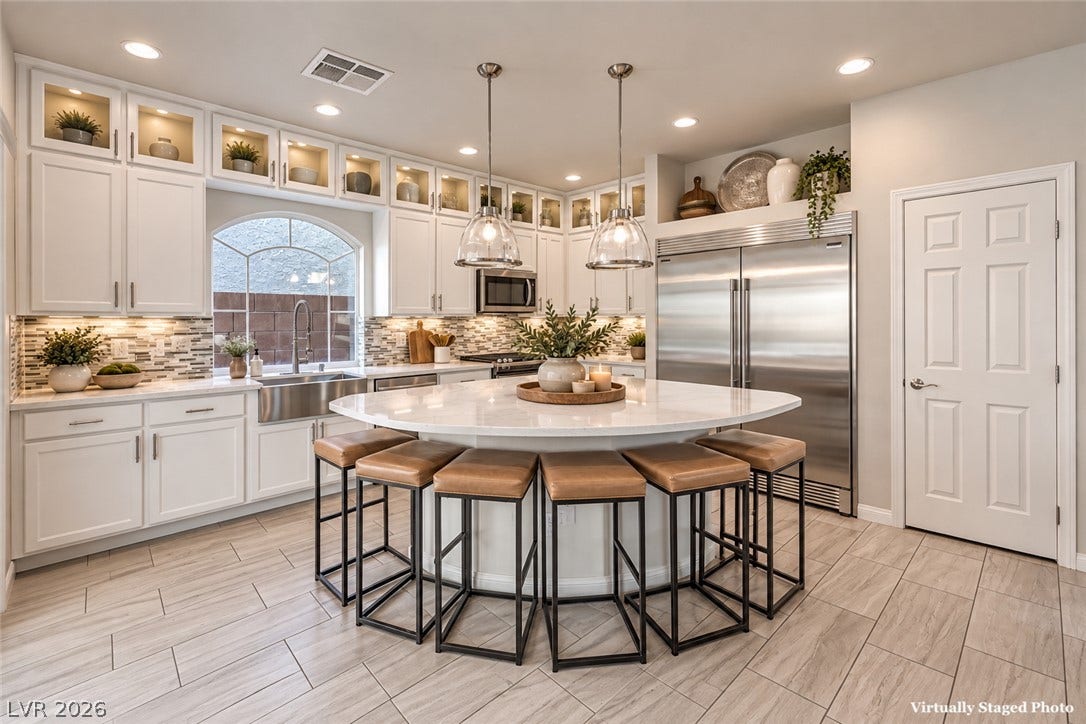 9267 Galen Glen Court, Las Vegas, NV 89139 Premium appliances and a massive curved island highlight this beautifully upgraded kitchen space.