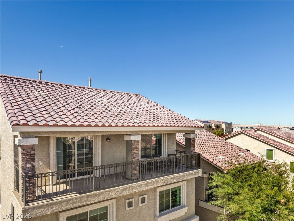 9267 Galen Glen Court, Las Vegas, NV 89139 An upper-level balcony overlooks the surrounding neighborhood under clear blue skies.