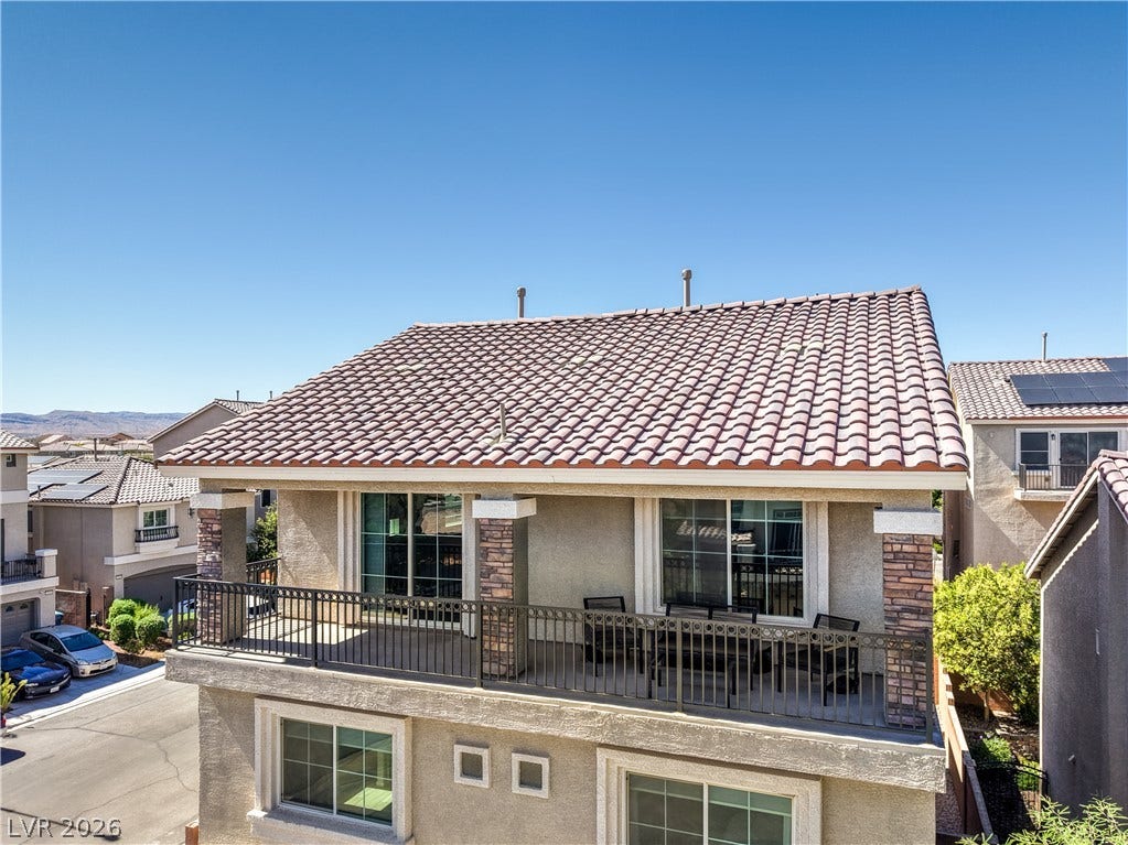 9267 Galen Glen Court, Las Vegas, NV 89139 An upper-level balcony is sheltered by a classic tile roof and sturdy stone-wrapped columns.