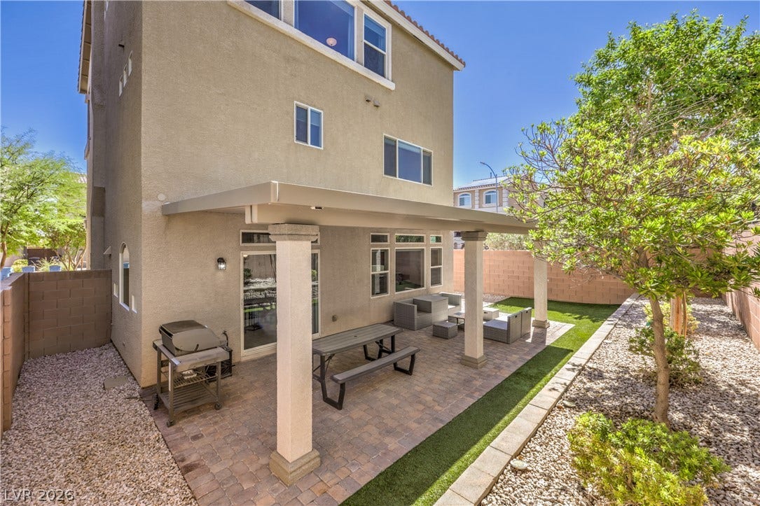 9267 Galen Glen Court, Las Vegas, NV 89139 An inviting covered patio featuring paver stones sits adjacent to a private backyard.
