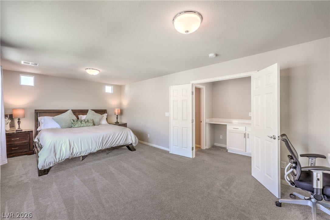 9267 Galen Glen Court, Las Vegas, NV 89139 Double doors open to reveal a built-in desk alcove within this spacious bedroom.