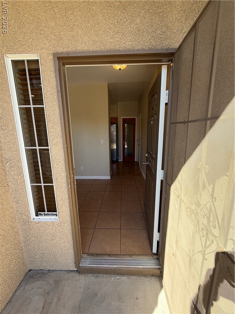 Tiled flooring meets exterior stucco walls at this welcoming entry point.