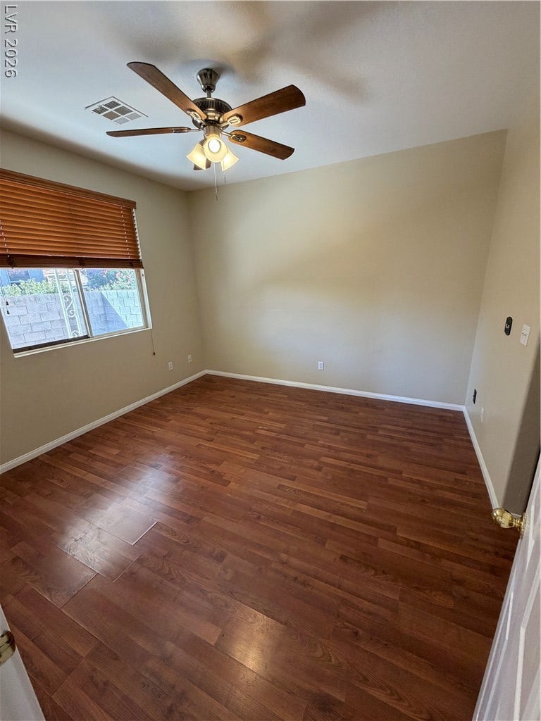 Rich wood-inspired floors and soaring vaulted ceilings define this versatile living space.