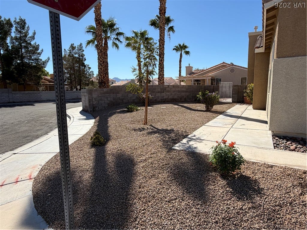 A low-maintenance desert landscape frames this tidy neighborhood setting.