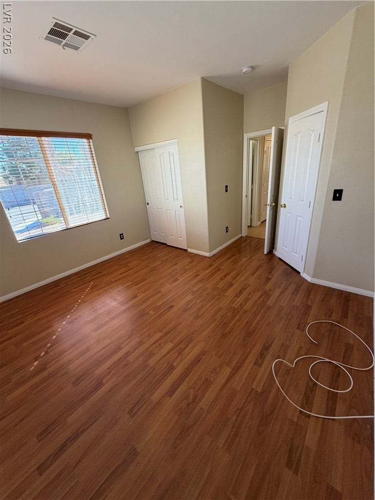 Rich wood floors and abundant natural light define this versatile interior space.