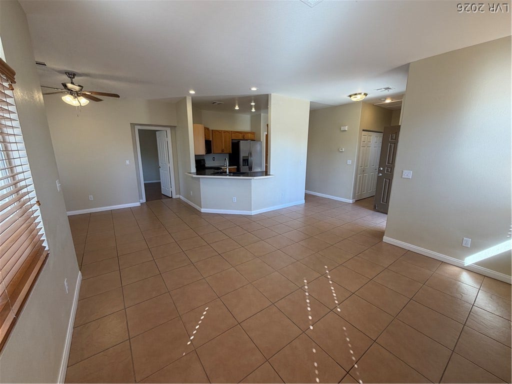 Tiled flooring and a modern open layout define this versatile living area.