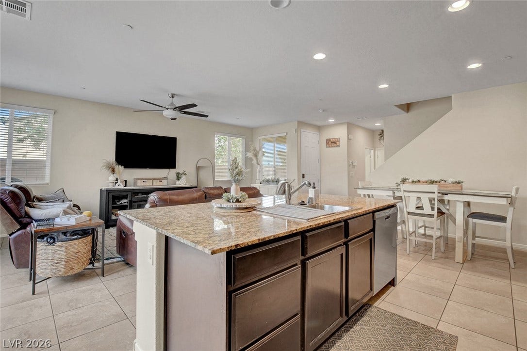 3924 Juanita May Avenue, North Las Vegas, NV 89032 An open floor plan seamlessly connects the kitchen island to the dining and living spaces.
