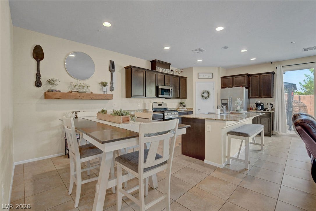 3924 Juanita May Avenue, North Las Vegas, NV 89032 Tiled flooring and recessed lighting accent this modern open kitchen and casual dining area.