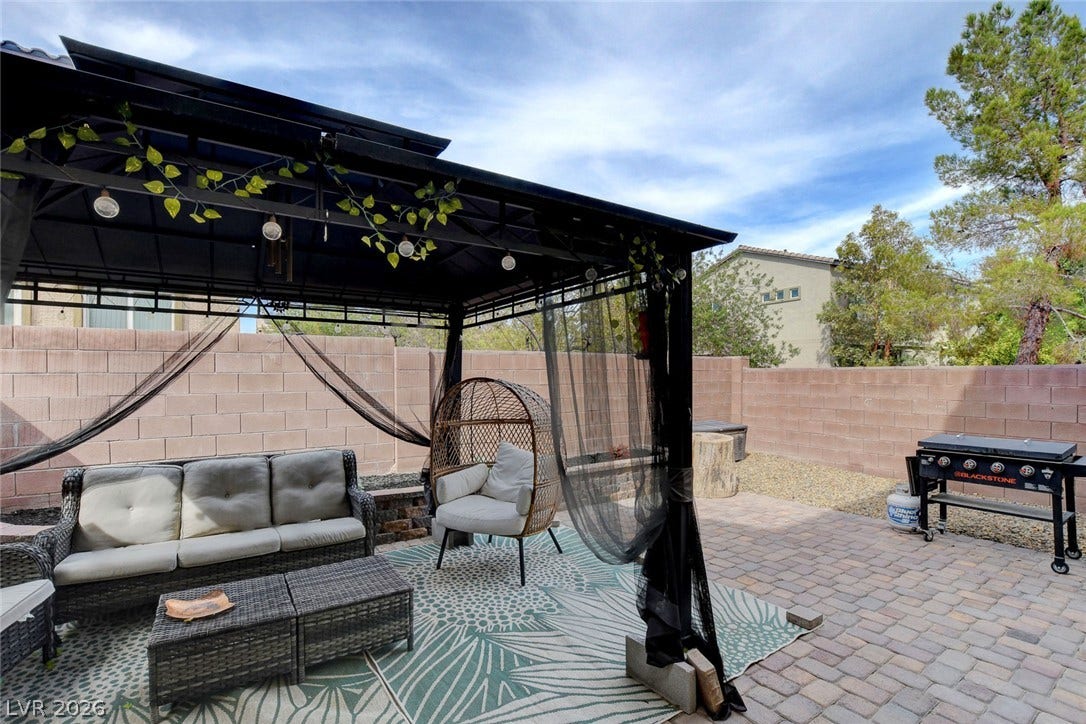 3924 Juanita May Avenue, North Las Vegas, NV 89032 An inviting paved patio features a substantial shade structure within a fully enclosed backyard.