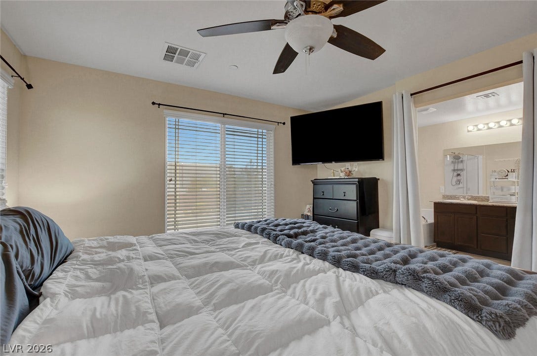 3924 Juanita May Avenue, North Las Vegas, NV 89032 An open doorway connects this comfortable primary bedroom directly to the adjacent master bathroom.