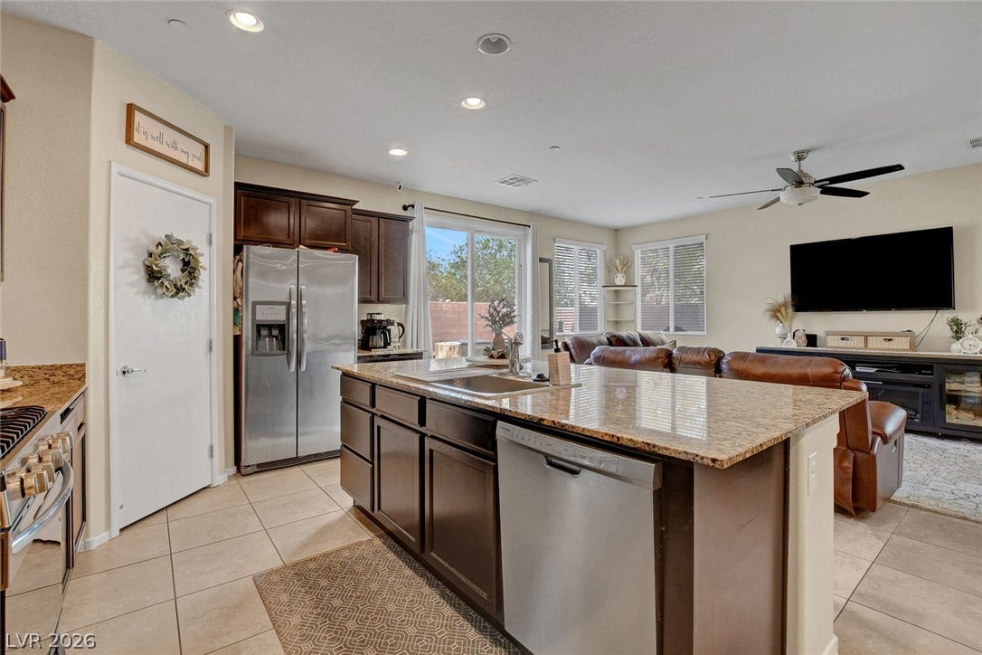 3924 Juanita May Avenue, North Las Vegas, NV 89032 Gleaming stone countertops and a spacious breakfast island anchor this modern open floorplan layout.