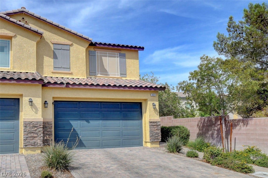 3924 Juanita May Avenue, North Las Vegas, NV 89032 Stucco and stone veneer exterior details complement the paved driveway and tile roof.