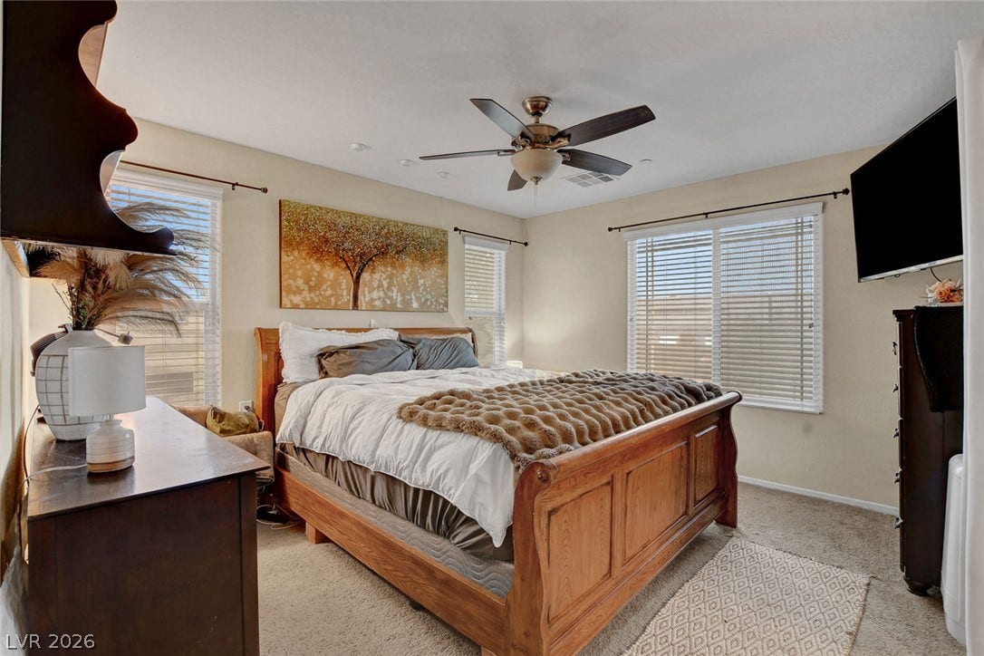 3924 Juanita May Avenue, North Las Vegas, NV 89032 Sunlight streams through multiple windows in this cozy carpeted bedroom.